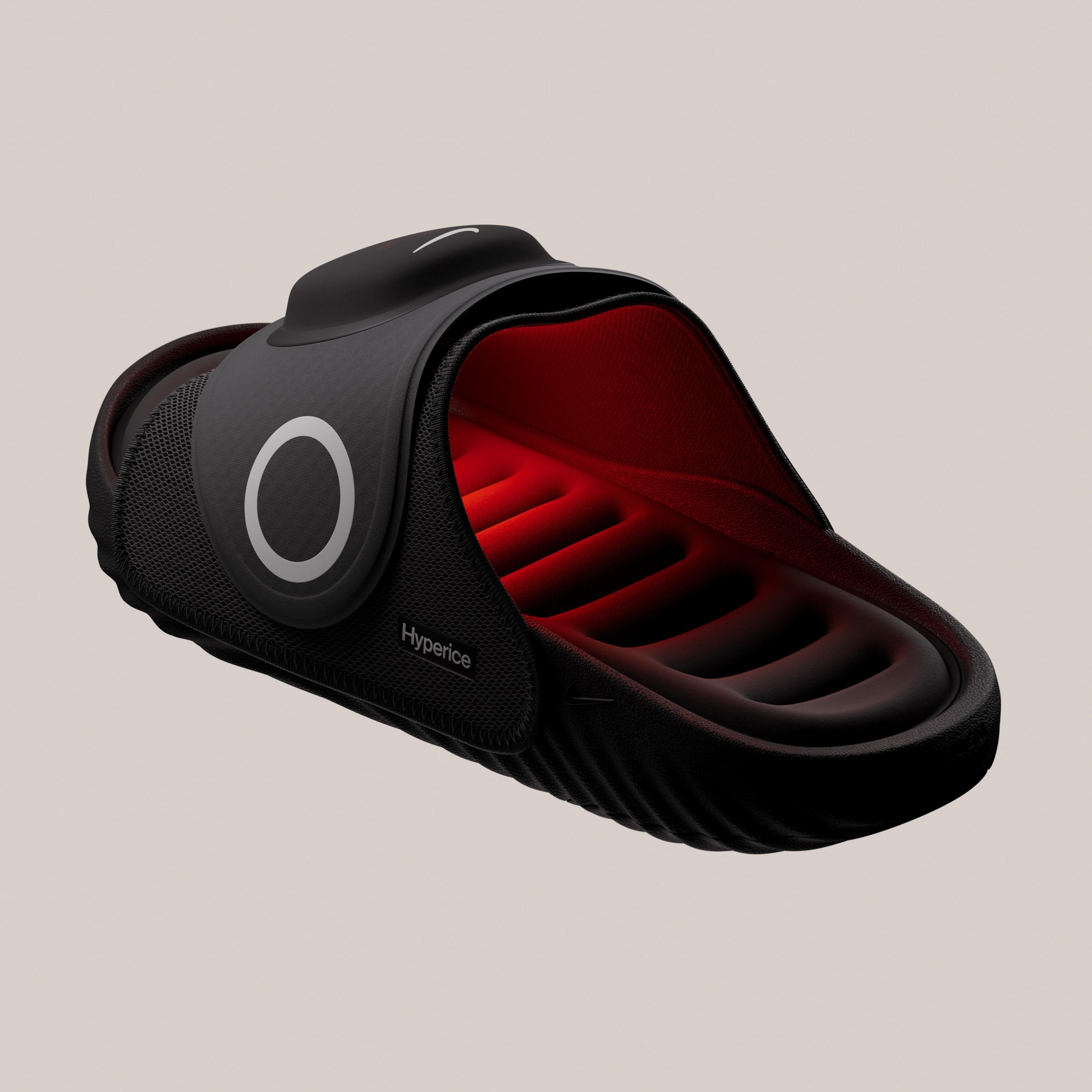 Angled view of the Nike Air Zoom Hyperslide showing the illuminated footbed, removable Hyperice recovery pod, and adjustable strap with integrated heat and vibration technology.