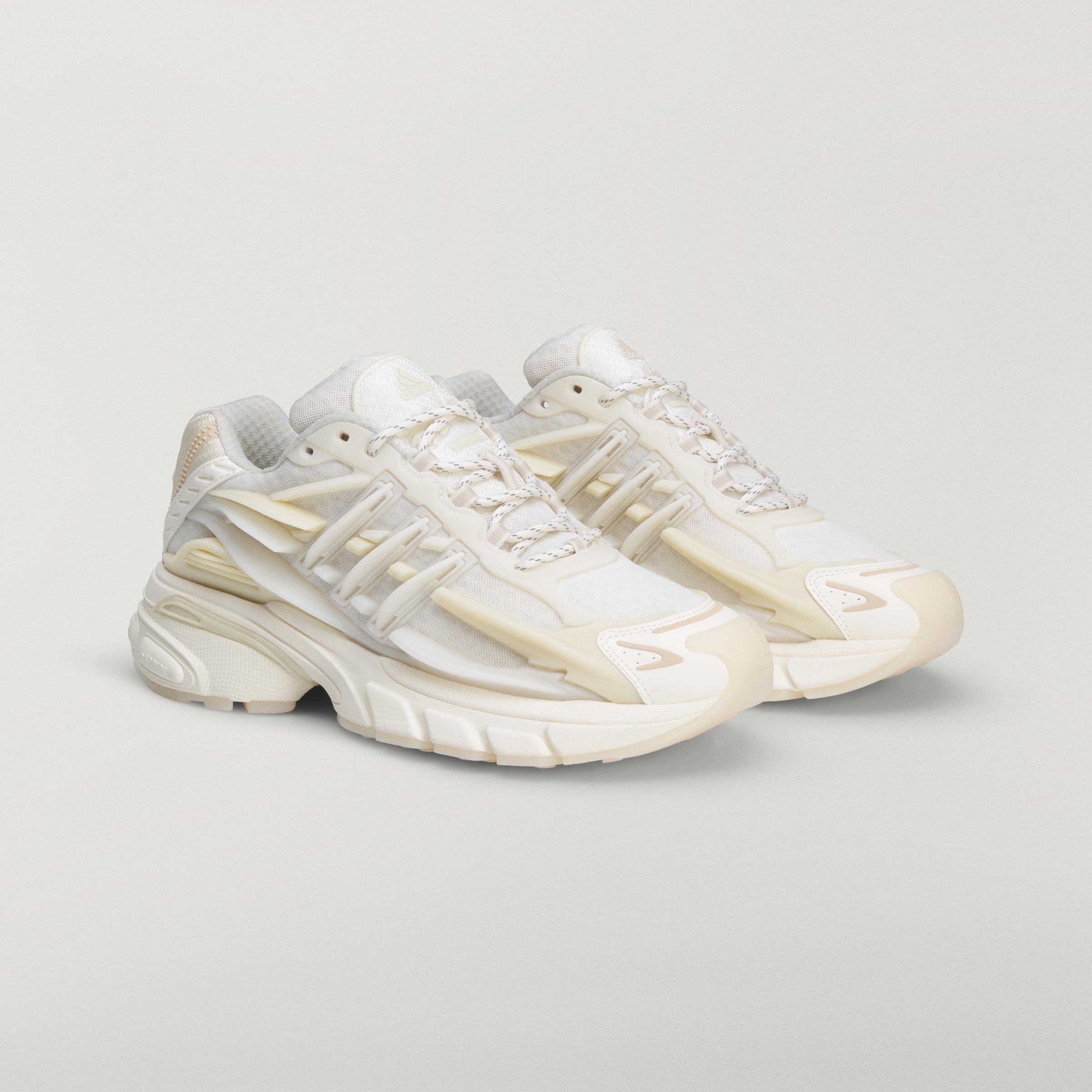 Angled view of a pair of adidas Originals x Pharrell Williams VIRGINIA Adistar Jellyfish sneakers in the Triple White colorway.