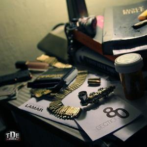 Cover of Kendrick Lamar’s 2011 album Section.80 featuring a cluttered desk filled with books, photographs, bottles, and personal objects.