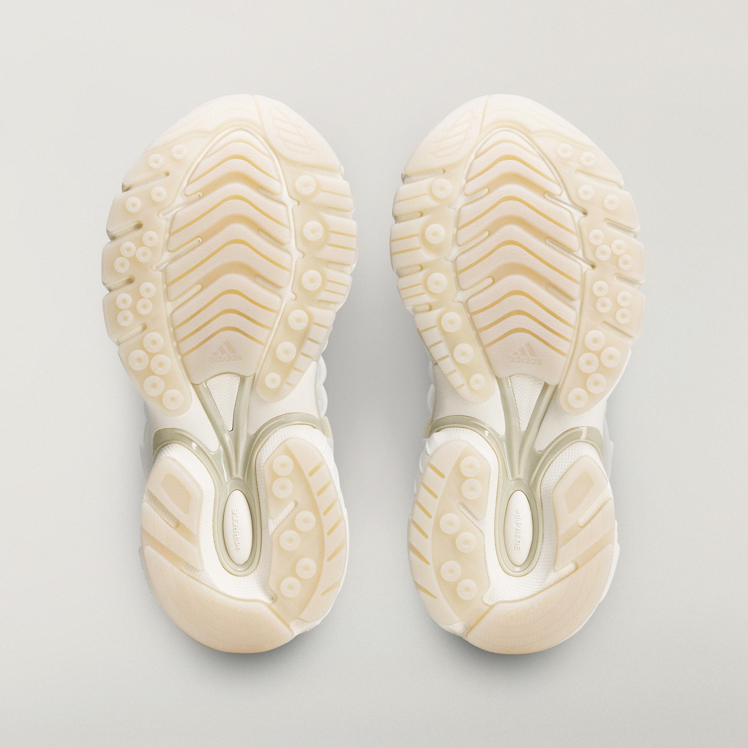 Bottom view of the adidas Originals x Pharrell Williams VIRGINIA Adistar Jellyfish Triple White outsole with textured traction pattern and glow-in-the-dark accents.