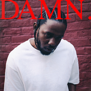 Cover of Kendrick Lamar’s 2017 album DAMN. featuring Kendrick in a white T-shirt against a red brick wall beneath the bold red album title.