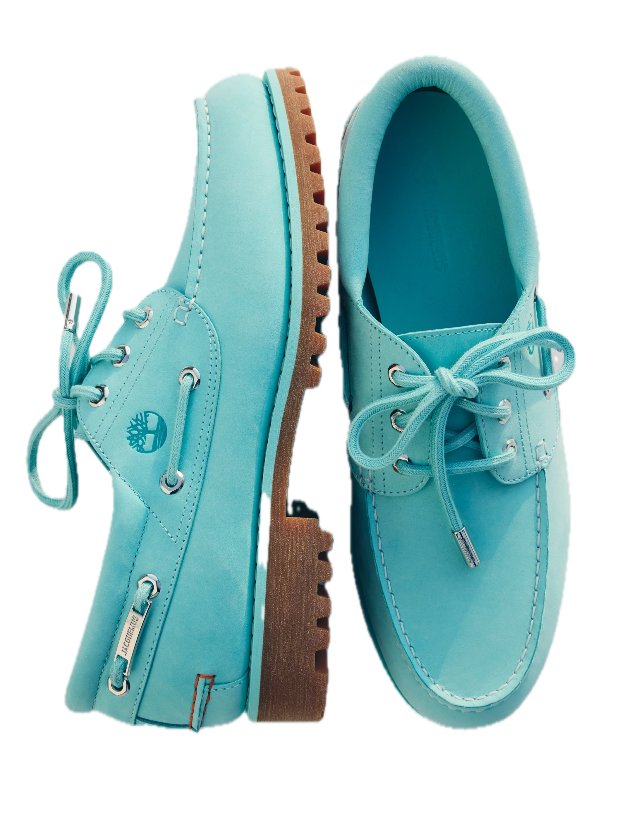 Side and top view of the Timberland x Jacquemus Authentic Boat Shoe in Lagoon Blue featuring premium leather, silver eyelets, tonal laces, and a rugged gum lug outsole.