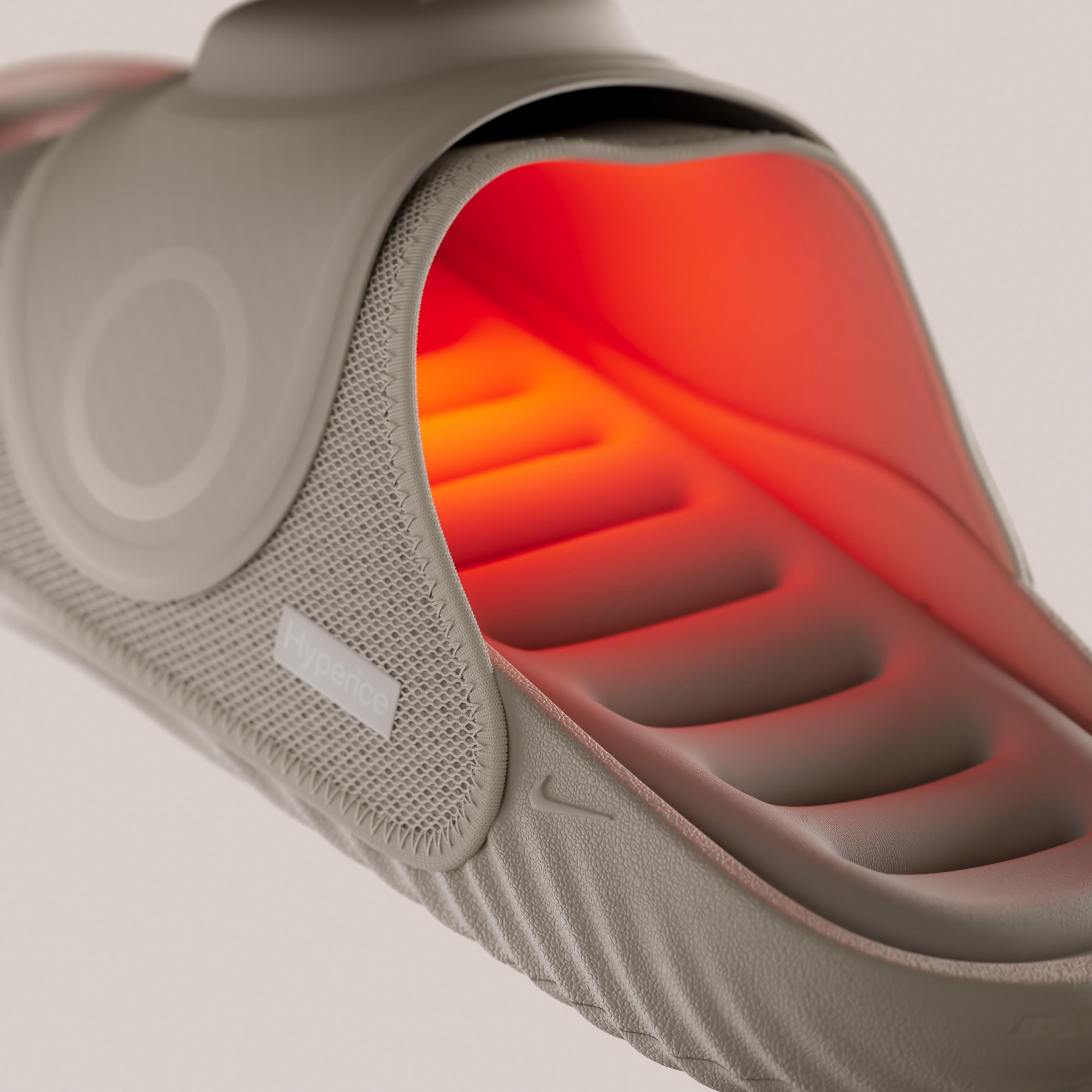 Close-up of the Nike Air Zoom Hyperslide showing the illuminated footbed with integrated Hyperice heat and vibration technology inside the recovery slide.